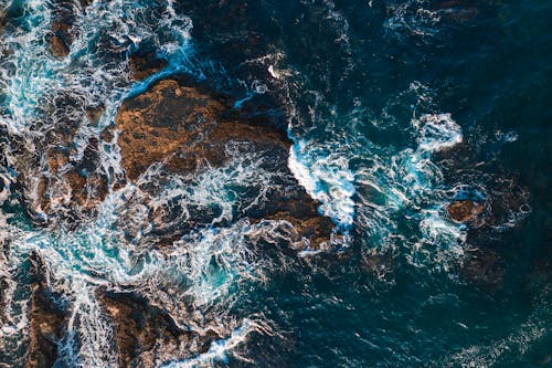 Waves Crashing on Blue Body of Water 