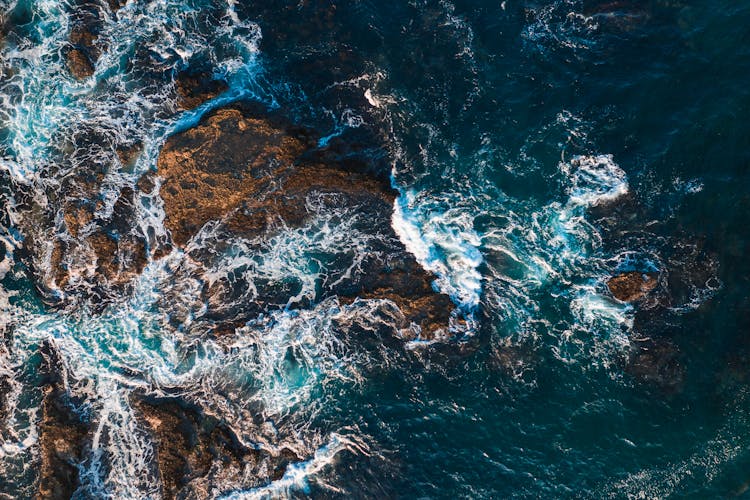 Waves Crashing On Blue Body Of Water 