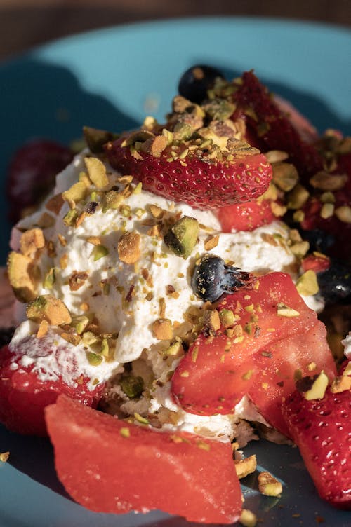 Whipped Cream with Strawberry Slices and Crushed Nuts