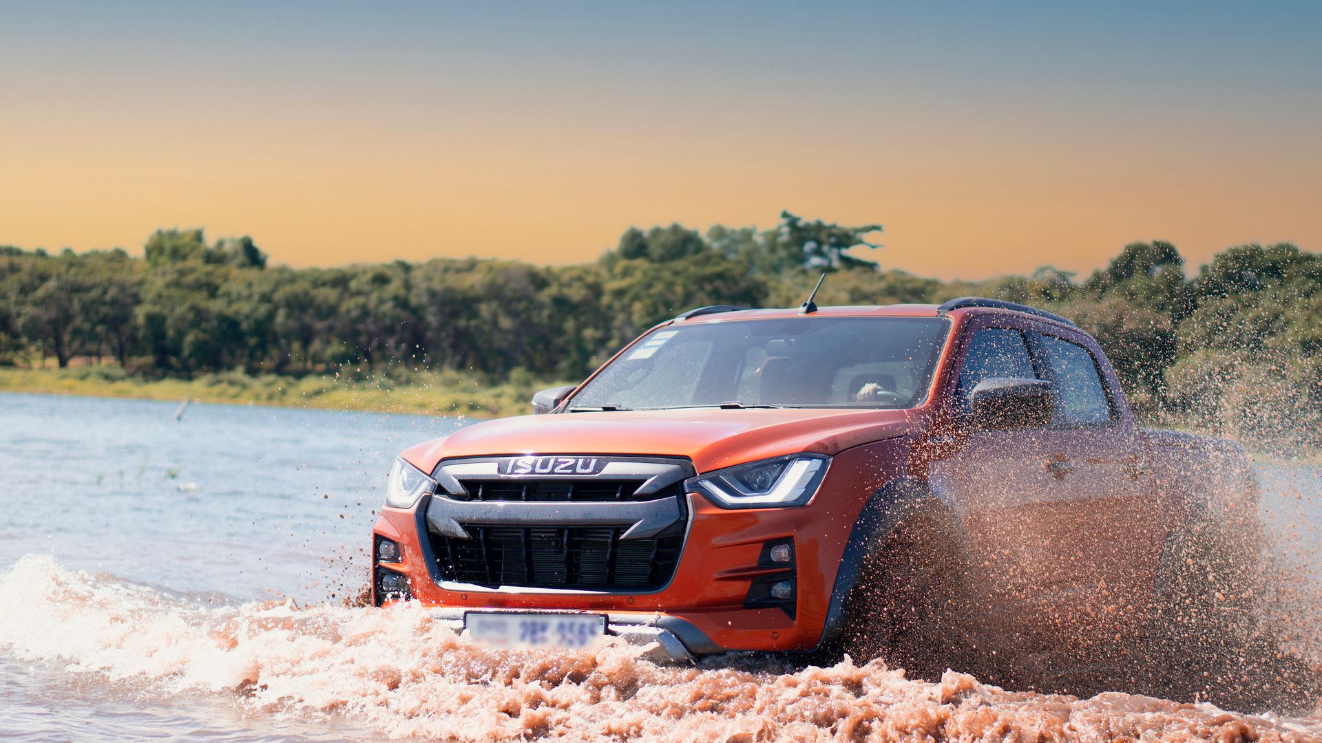 Dynamic shot of an Isuzu pickup truck splashing through water in Phnom Penh, Cambodia.
