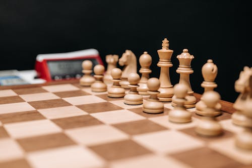 Wooden Chess Pieces on Chess Board