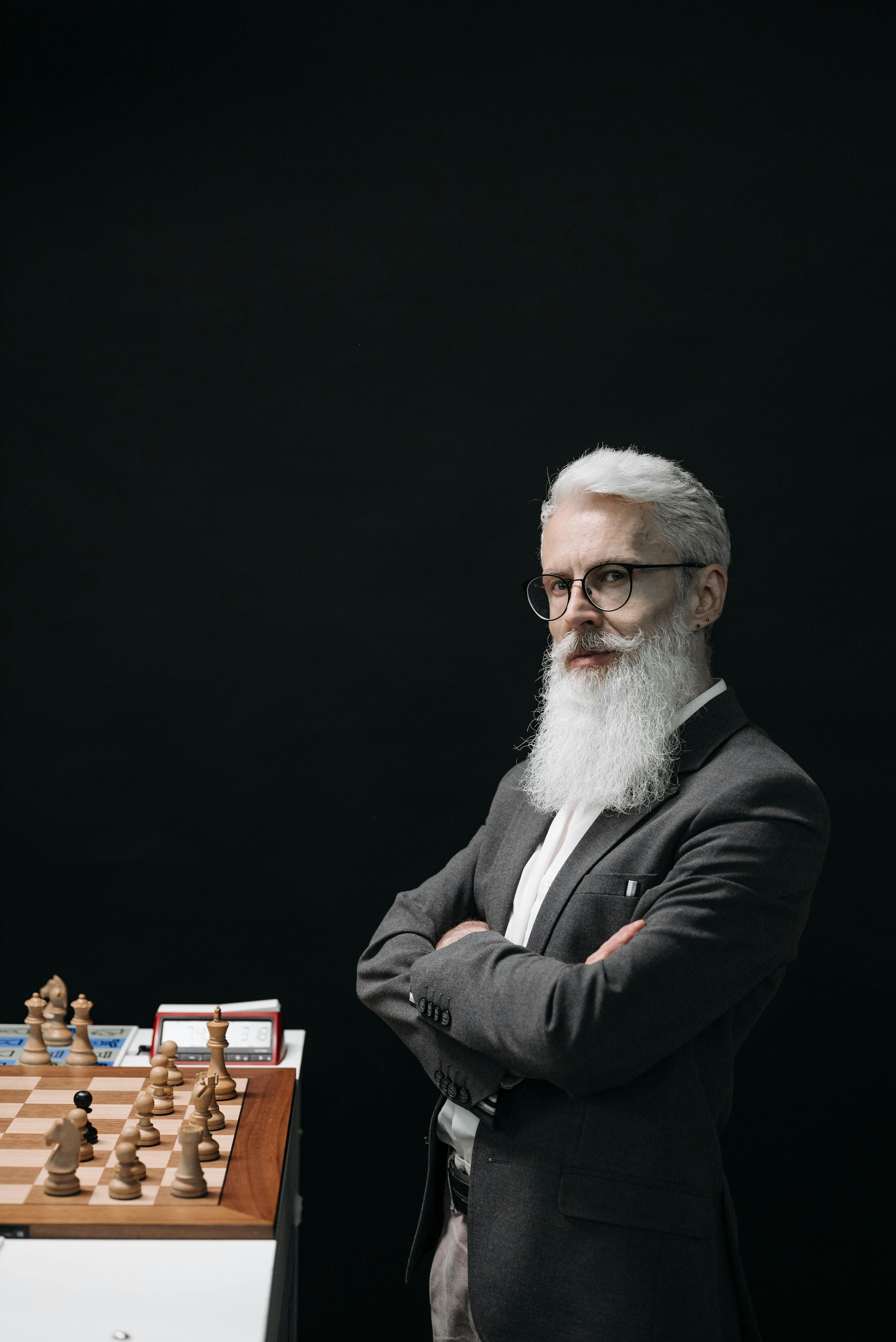 a bearded man playing chess