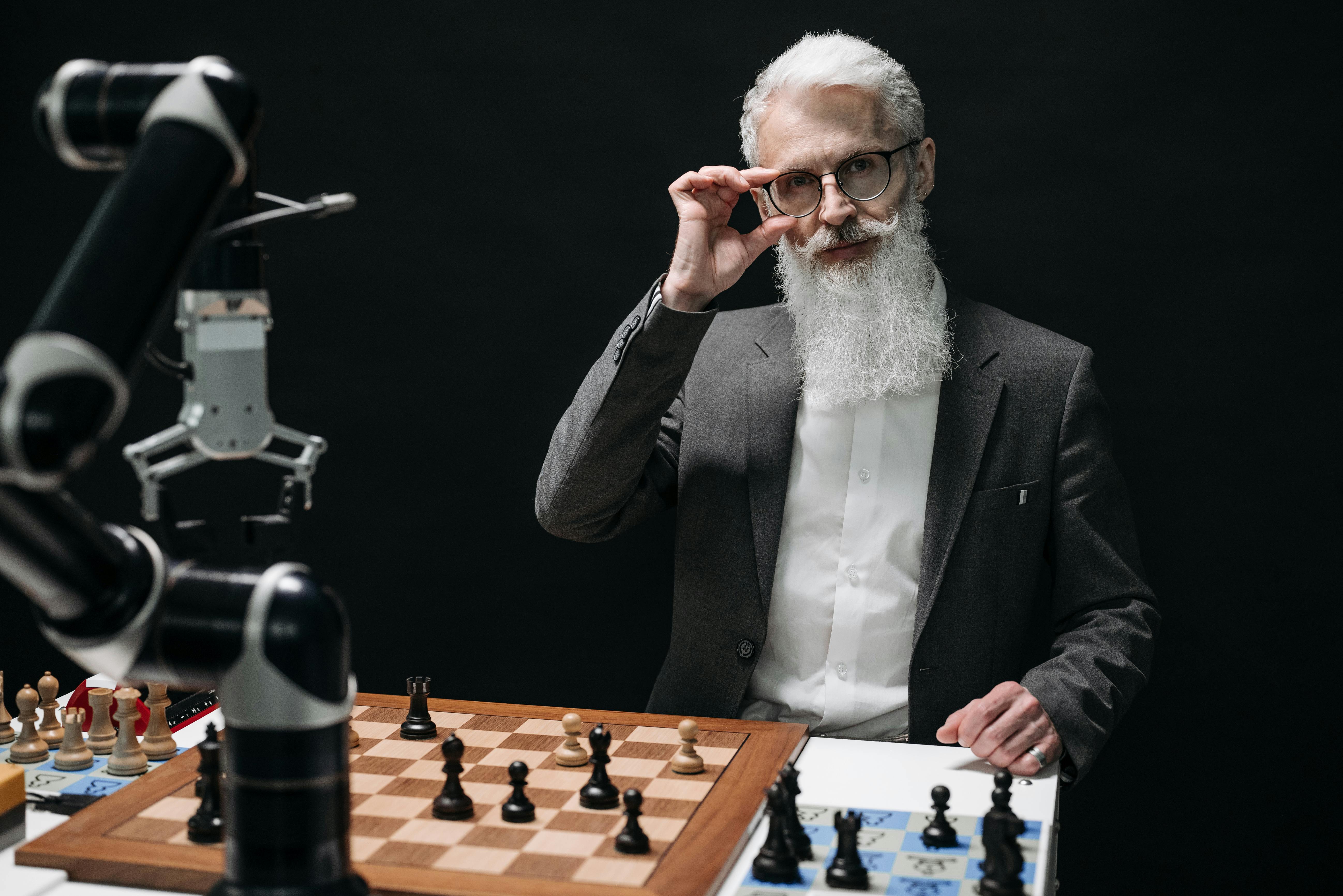 man playing chess with a robot