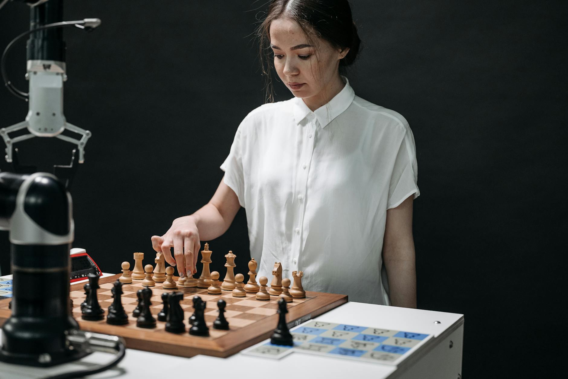 Woman Playing Chess against a Robot