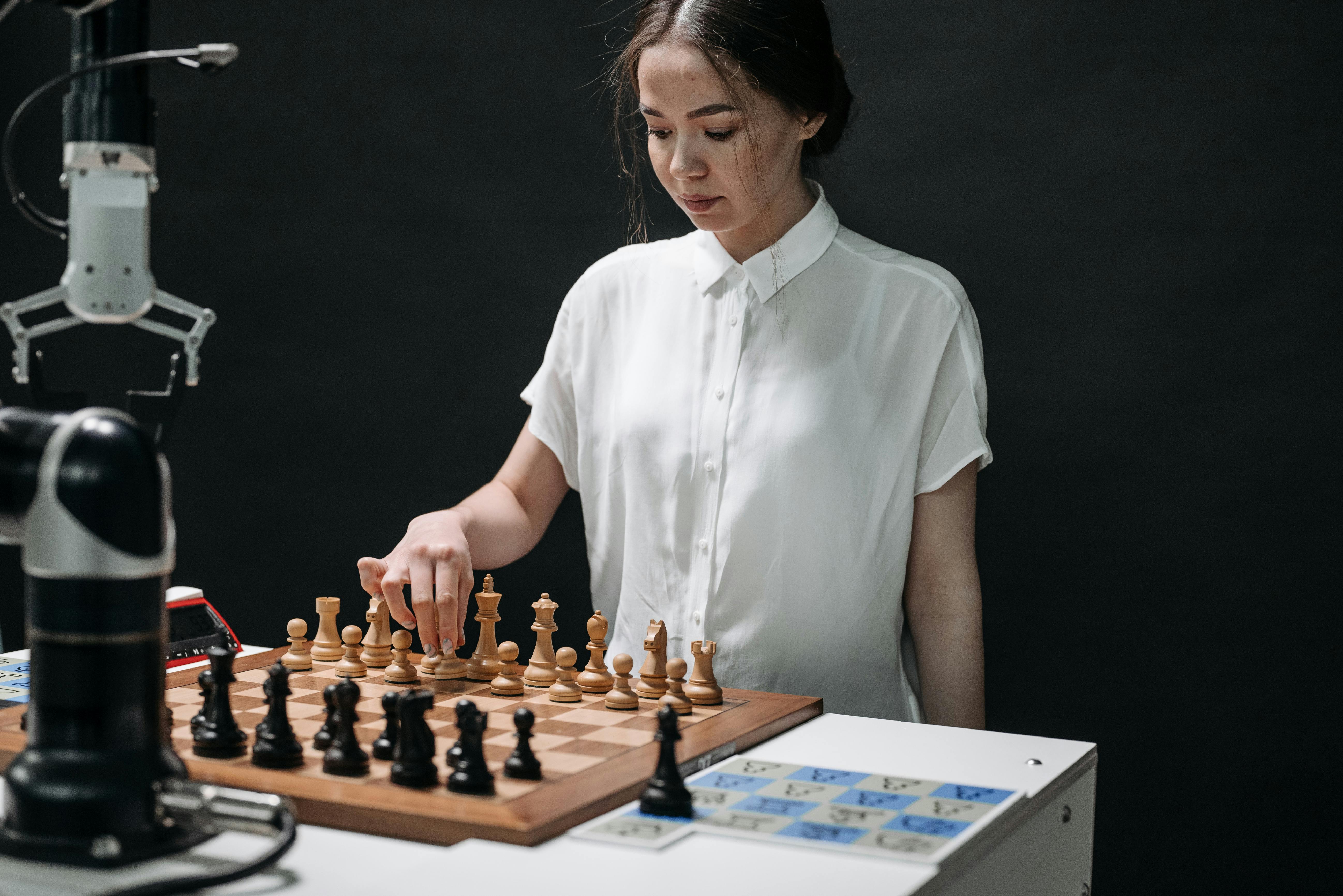 Premium Photo  Woman playing chess online uses laptop