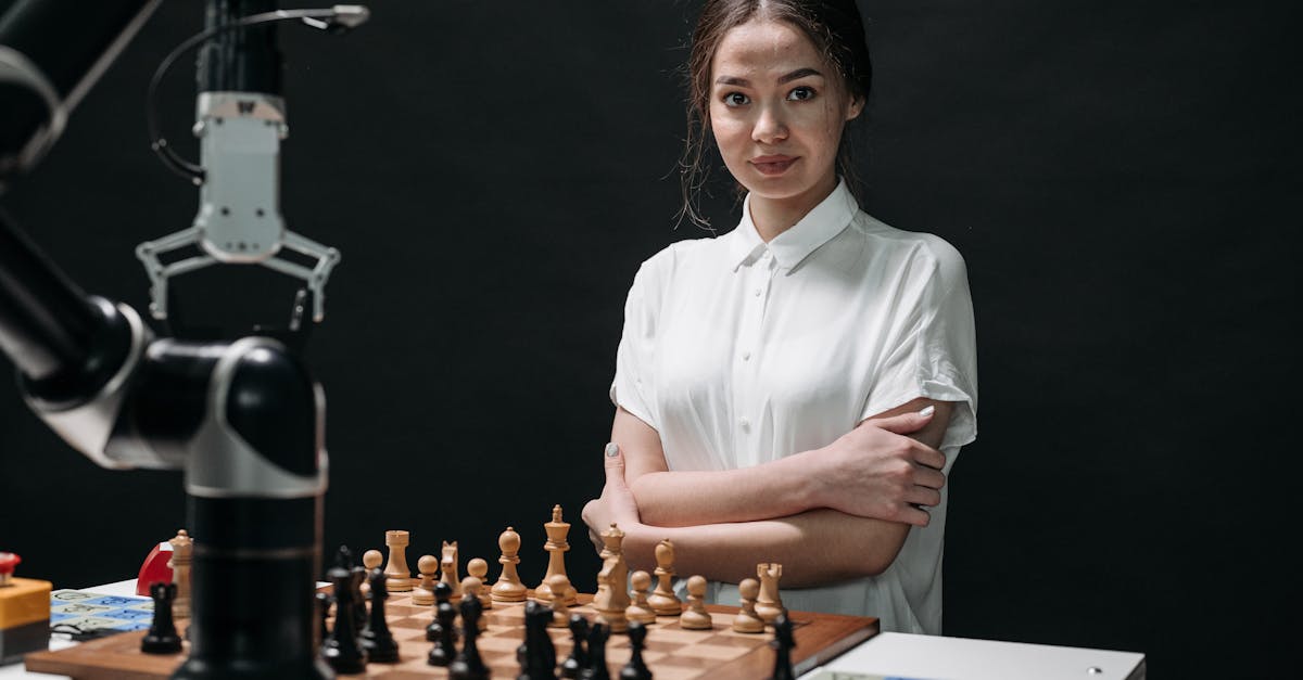 A young woman in a white blouse playing chess against a robot arm.