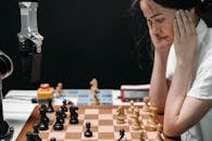 Woman in White Tank Top Playing Chess