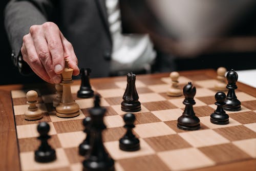Free Hand Holding a Chess Piece Stock Photo