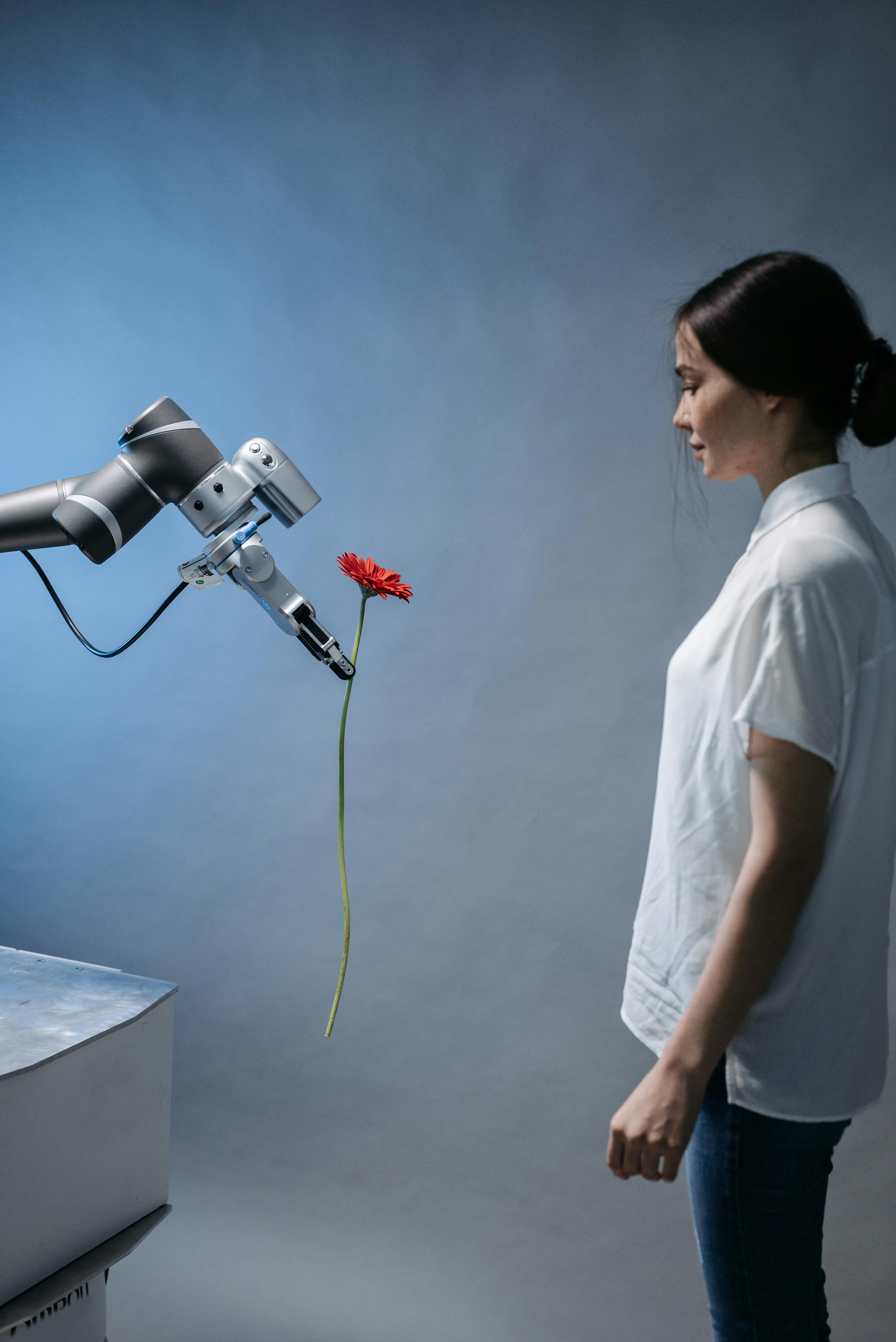 a robot giving a woman a flower