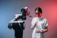 Man in White Button Up Shirt Holding Red and Black Corded Headphones