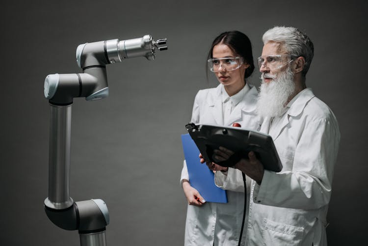 Man And Woman In White Lab Coats Testing A New Machine