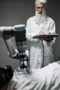 Man in White Robe Holding Smartphone