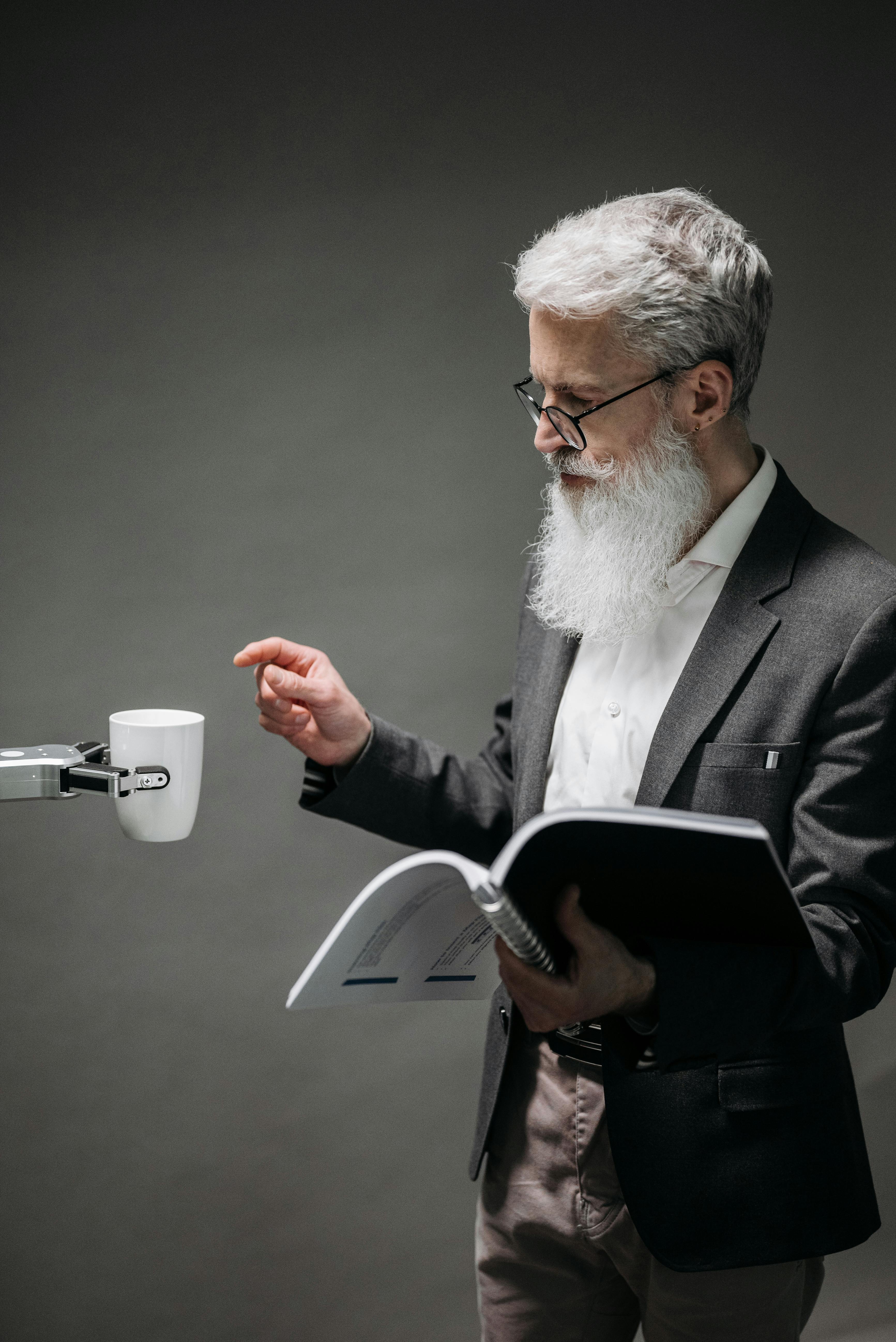 robot handing a mug of coffee to a man reading technical documentation