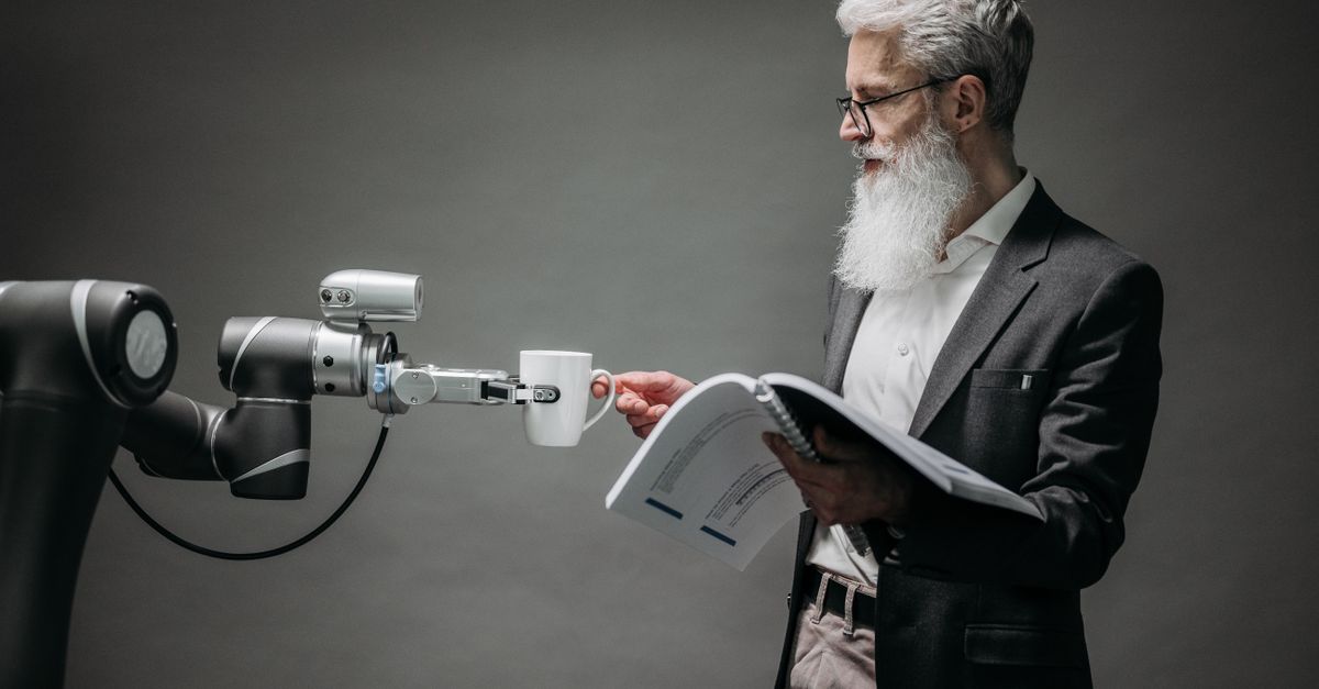 Photo by Pavel Danilyuk A scientist interacts with a robot helper, demonstrating modern technological innovation.