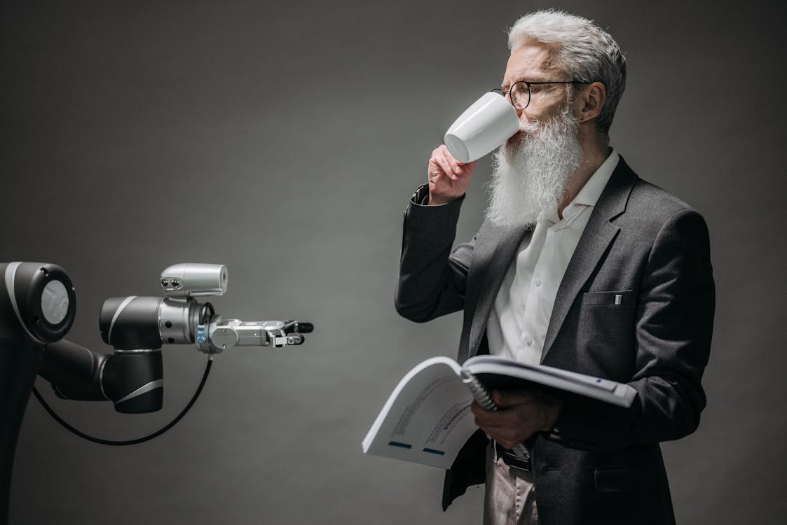 Free A Robot Holding a Cup Stock Photo