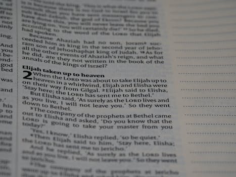 Close-up of a Bible page featuring the story of Elijah taken to heaven.