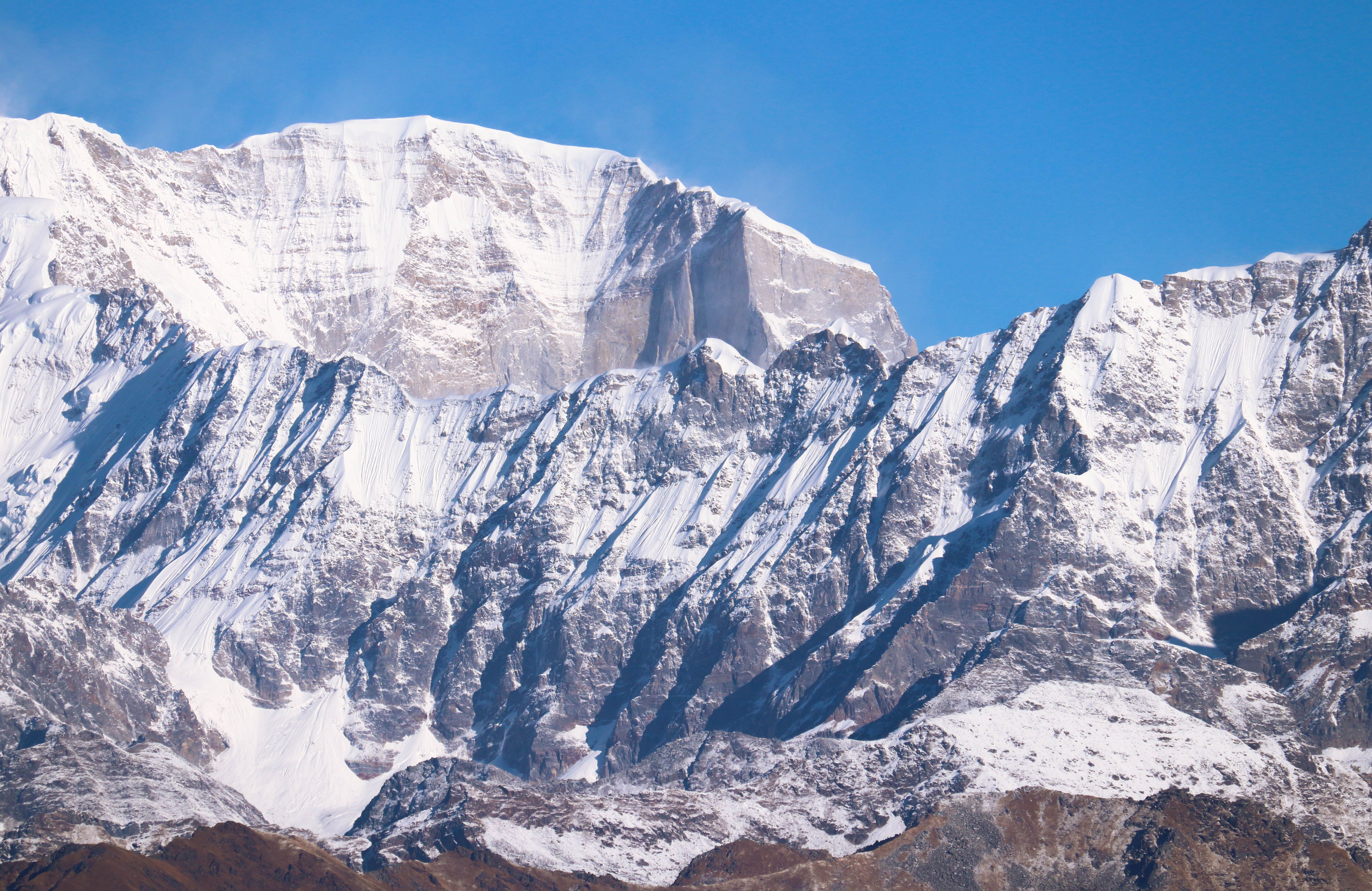 Clear Blue Sky over a Snow Covered Mountain · Free Stock Photo