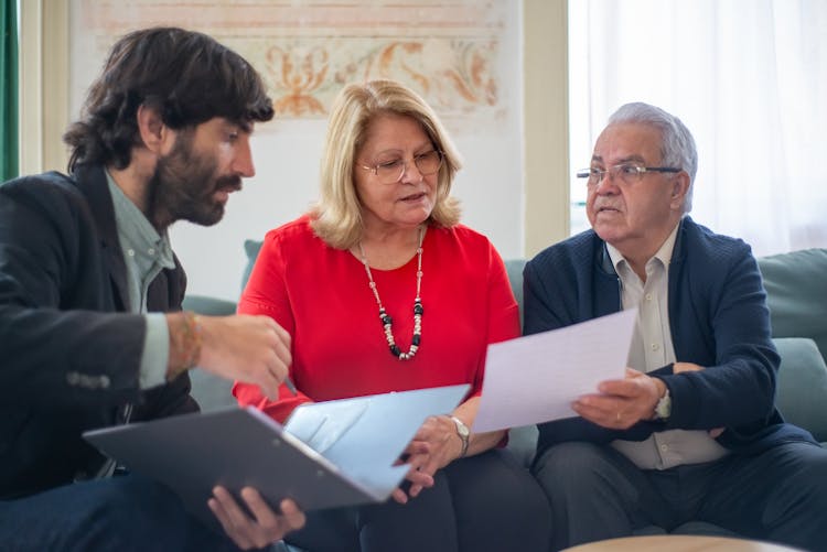 A Man Talking To The Elderly Couple