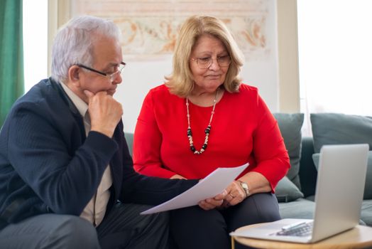 senior couple discussing finances at home