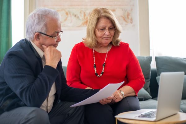 Couple reviewing their life insurance policy with an advisor
