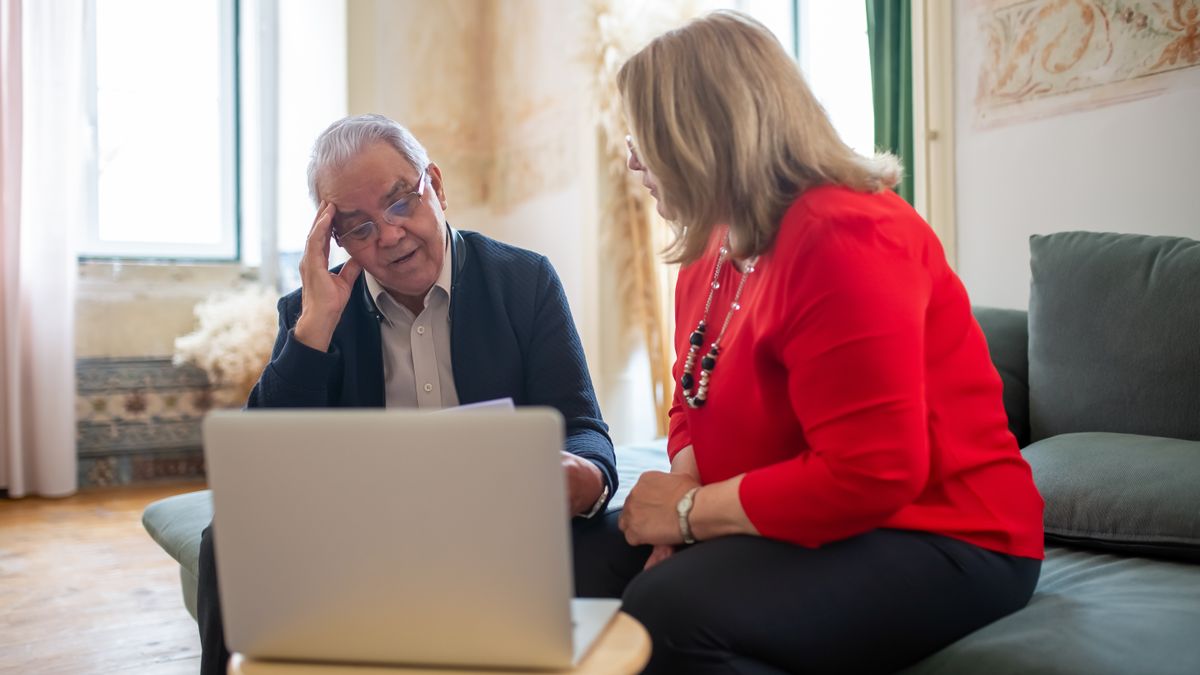 Executive reviewing risk checklist at a desk