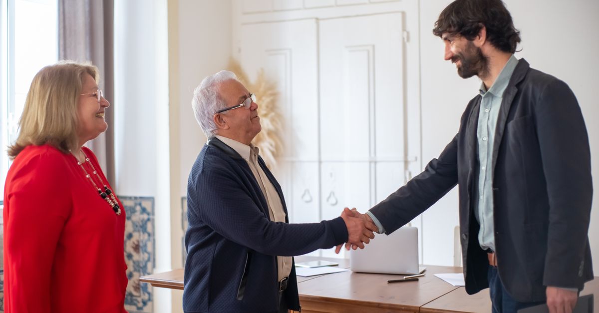 Two people sealing a business agreement with a handshake in a bright office