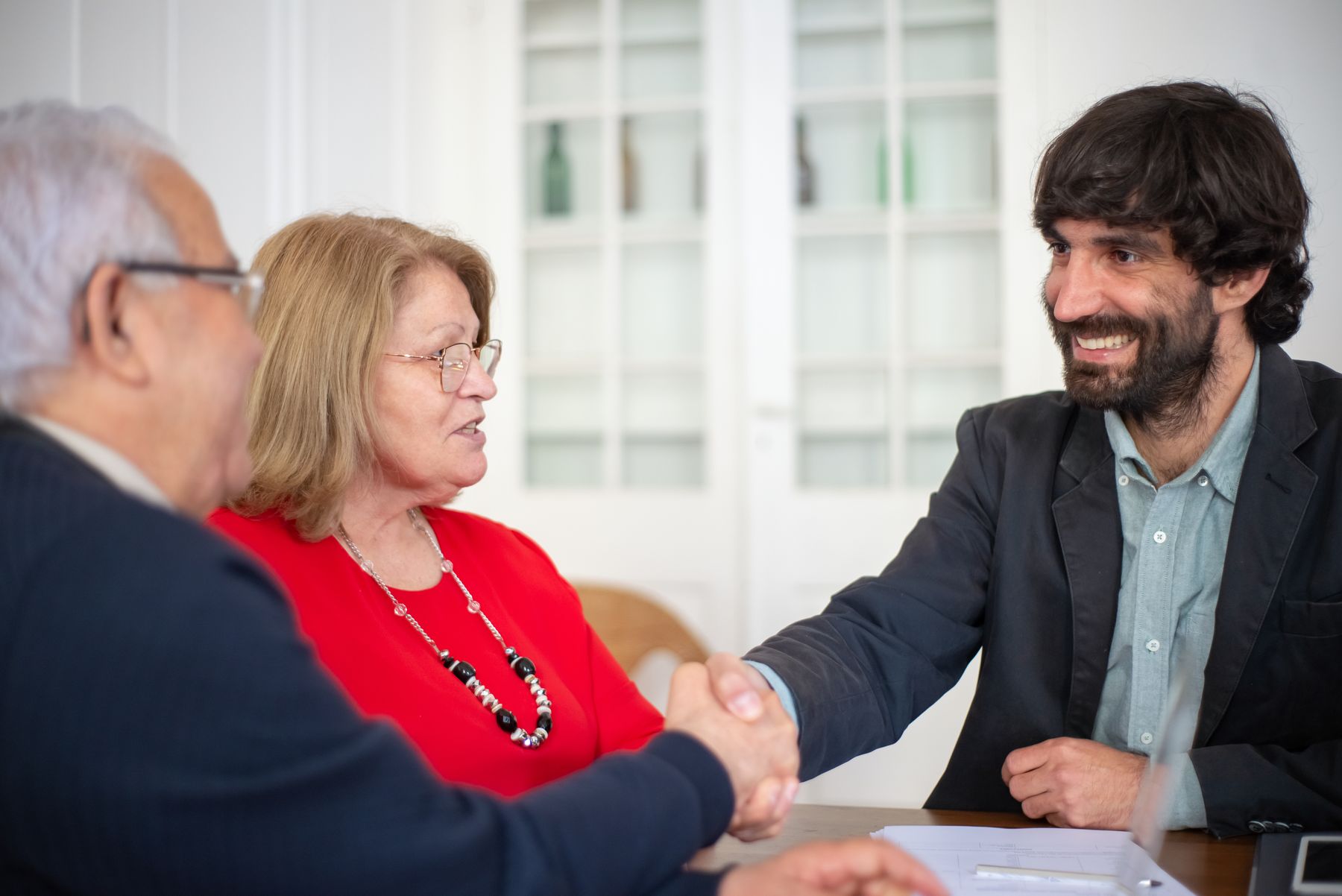 Professionals shaking hands at an international employment consultation meeting