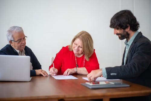 Woman Signing a Document in an Office