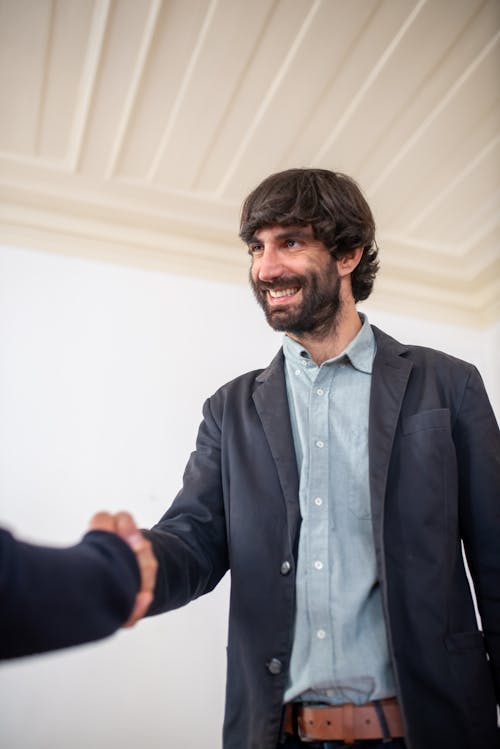 Free Man Shaking Hands with a Client Stock Photo