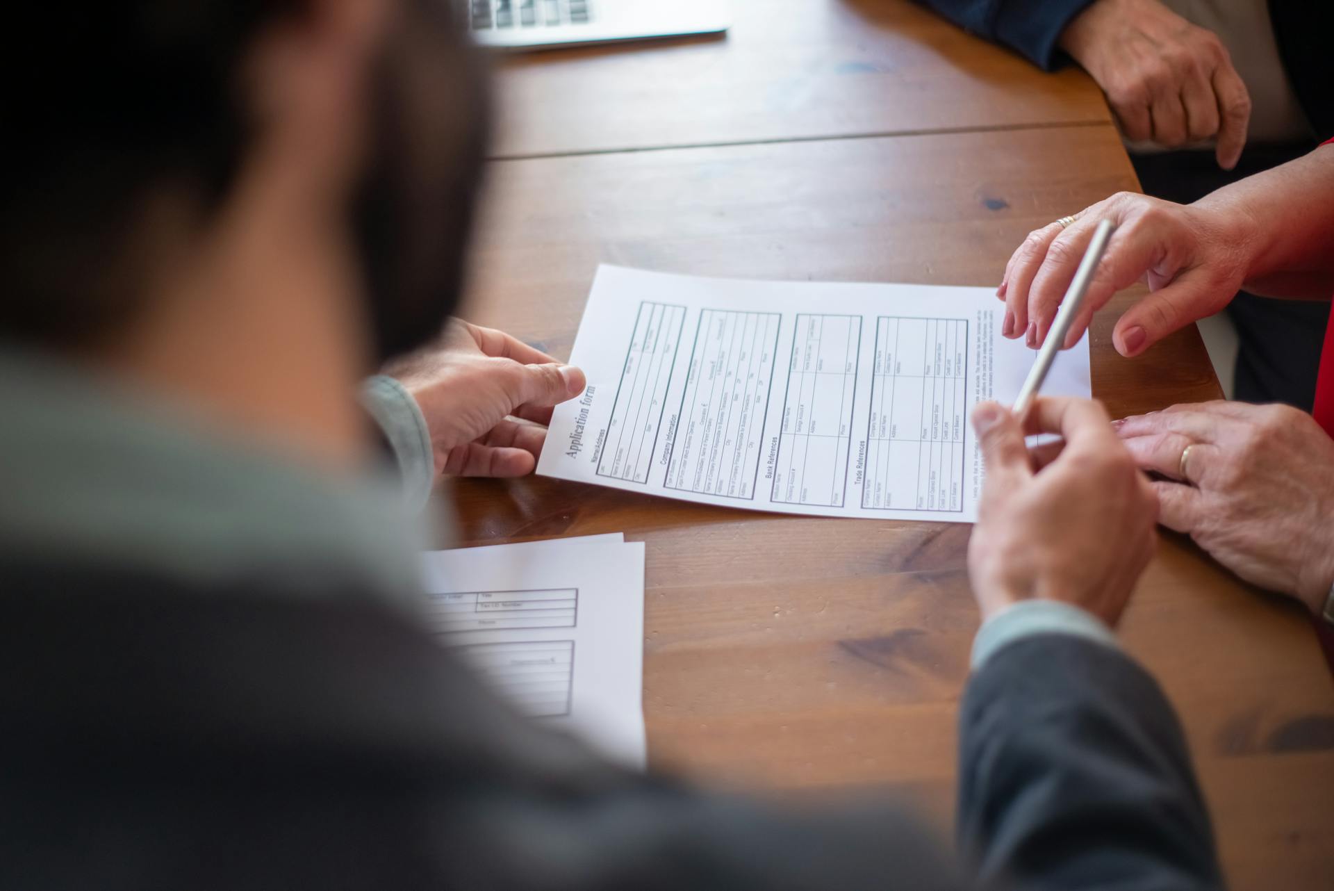 An Agent Handing a Pen to a Client