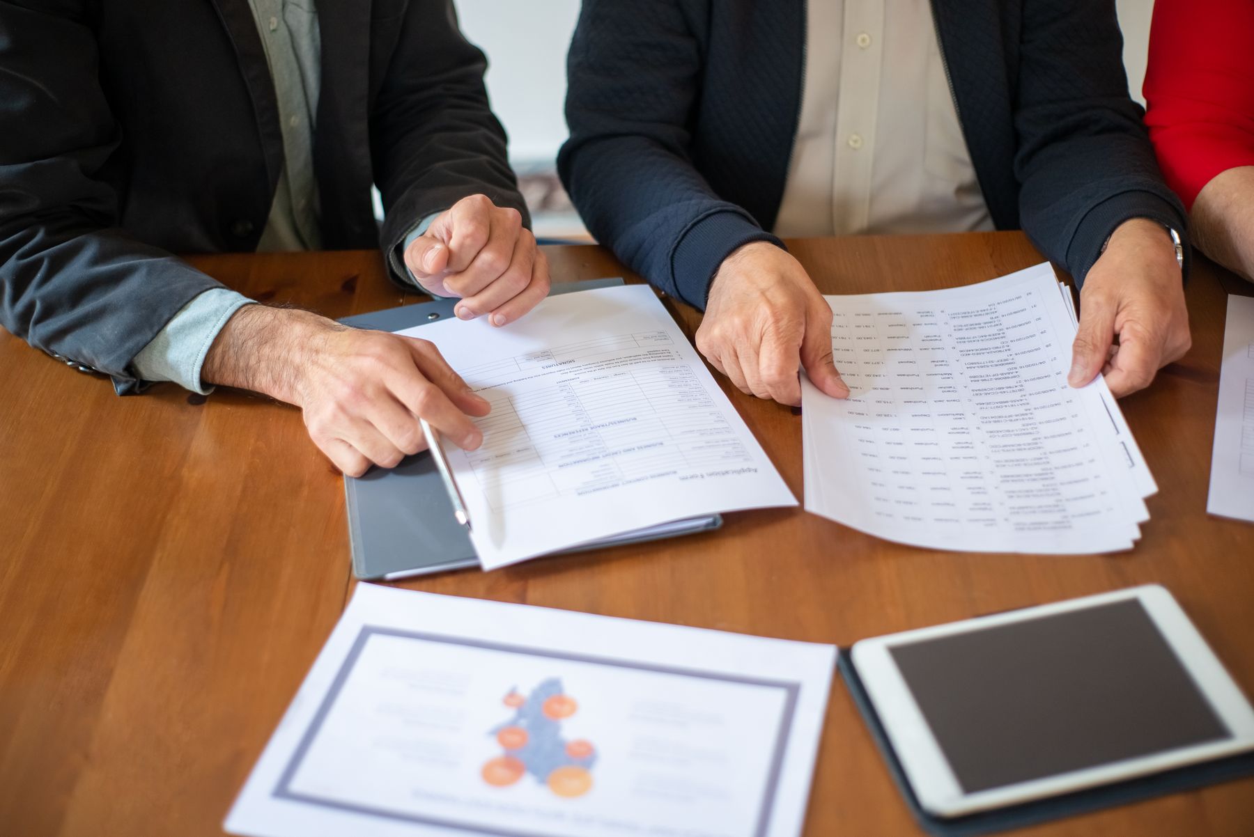 Professionals reviewing documents during a business meeting