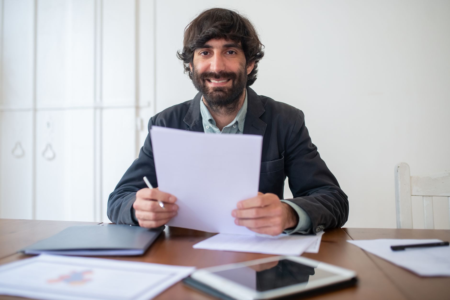 Automated Billing for Small Business: Profit Boost 2 business owner happily reviewing financial reports on a tablet