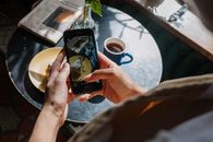 Person Taking Picture of Piece of Cake