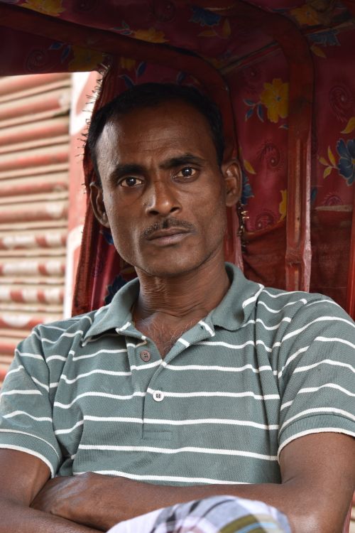 Free Close-up portrait of a man in a striped polo shirt with a serious expression. Stock Photo
