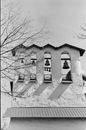 Bells on a Concrete Tower Near Bare Tree Branches