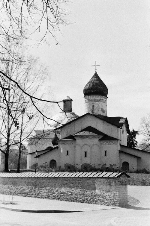Free Black and white image of an old monastery featuring classic onion dome architecture and stone wall. Stock Photo
