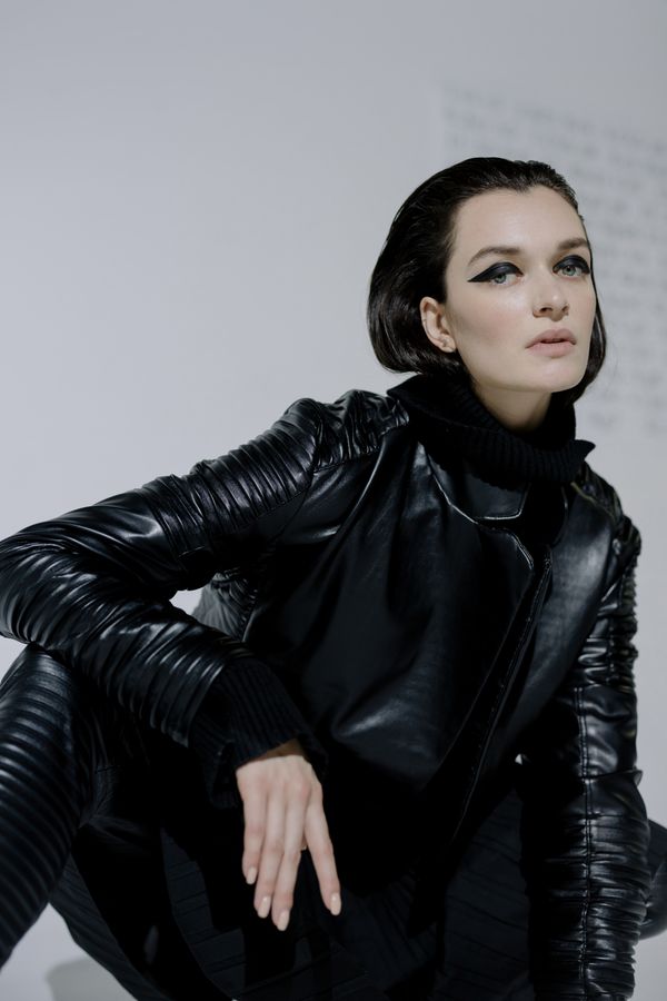 Woman in black turtleneck and leather jacket