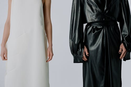 Free Women in a White Dress and a Black Leather Trench Coat Stock Photo