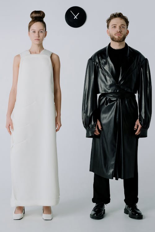 Man Wearing a Leather Coat and a Woman in a White Dress