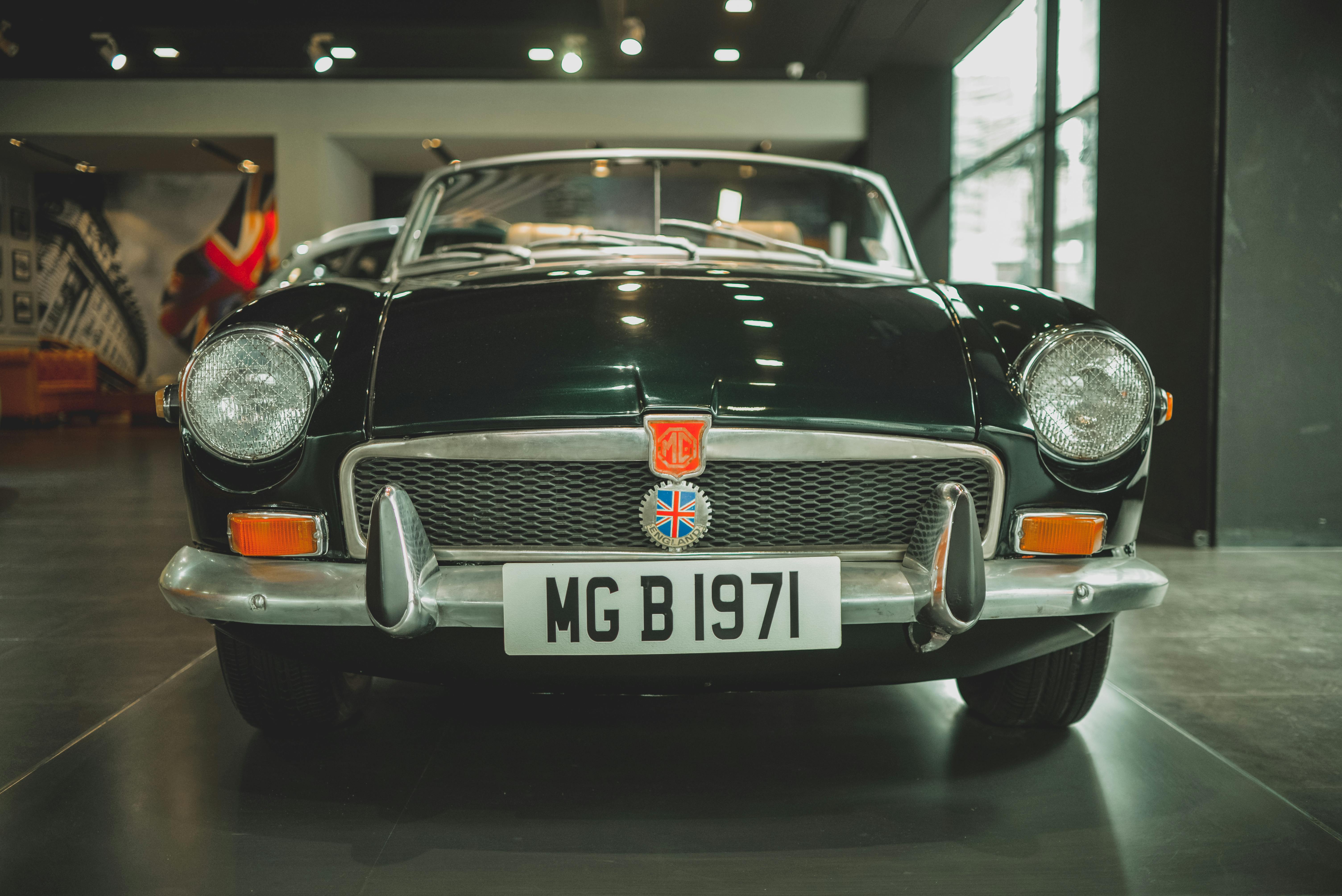 Explore this stunning 1971 MG B classic car displayed in an elegant indoor showroom setting.