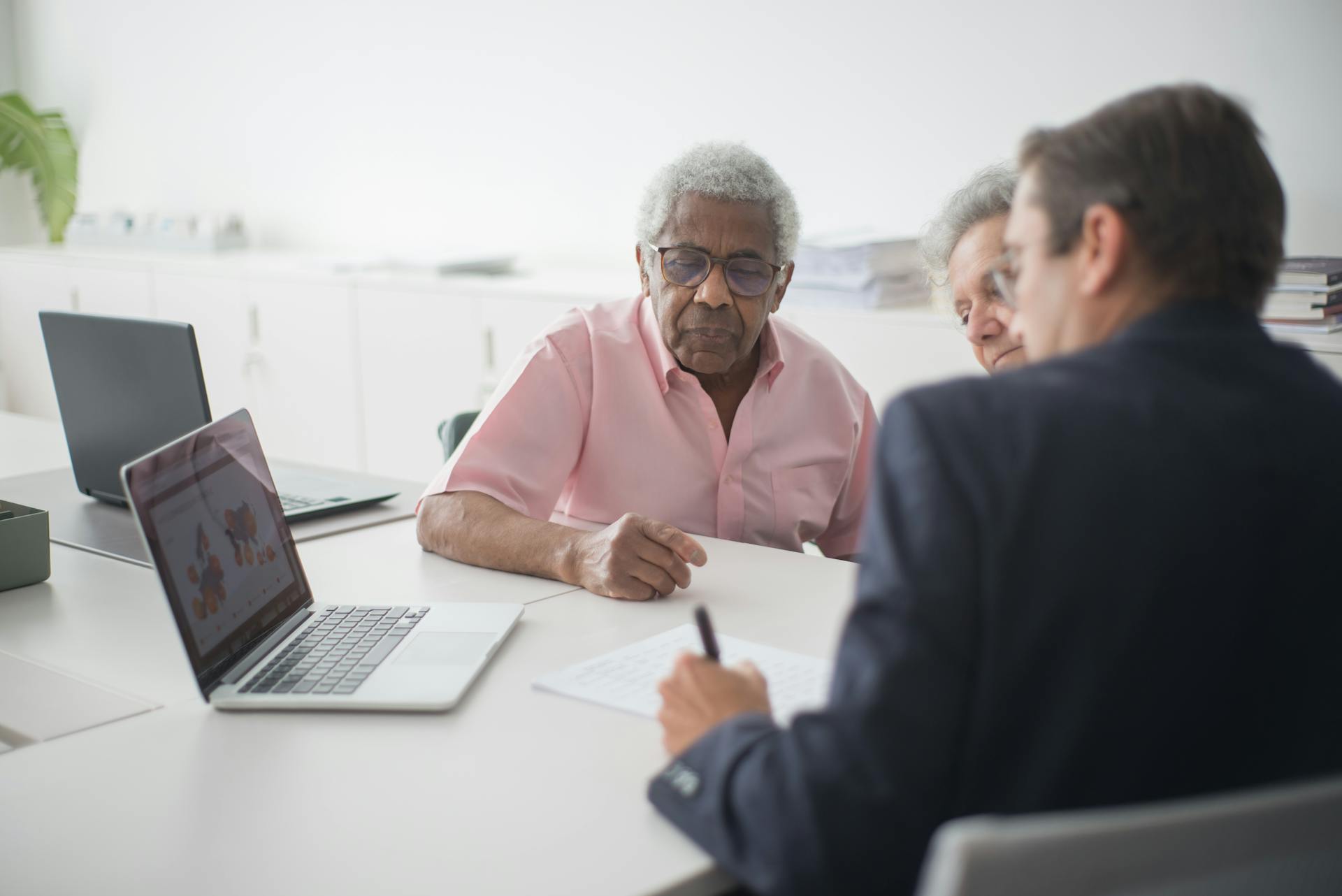 Elderly Couple Discussing Contract with Consultant