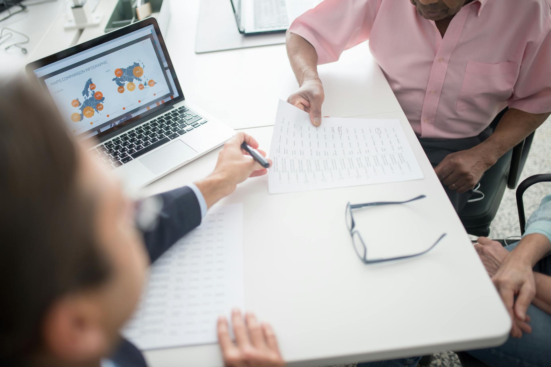 Insurance Broker Presenting an Offer to an Elderly Couple