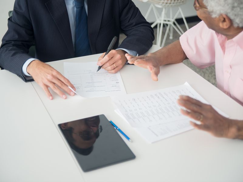 Business consultant discussing documentation with a client