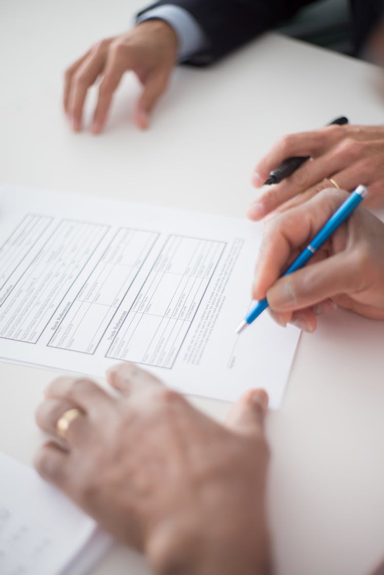 A Person About To Sign The Document