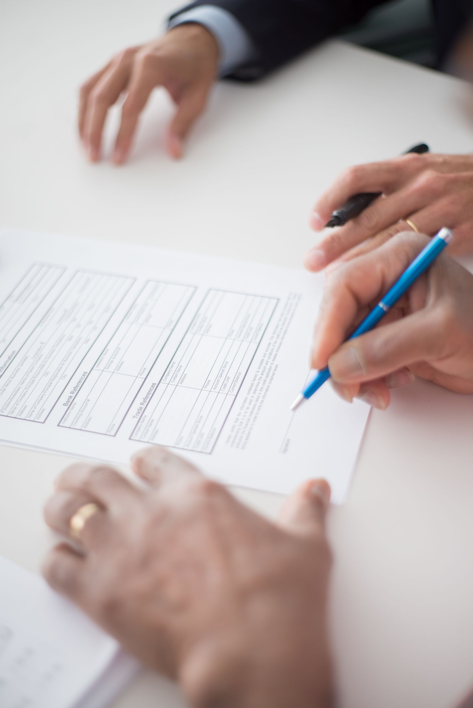 Close-up of hands signing a business document, the formality section 204(a) requires