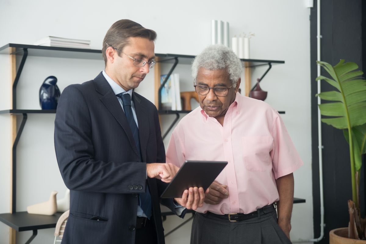 Person reviewing retirement investment documents and financial assets