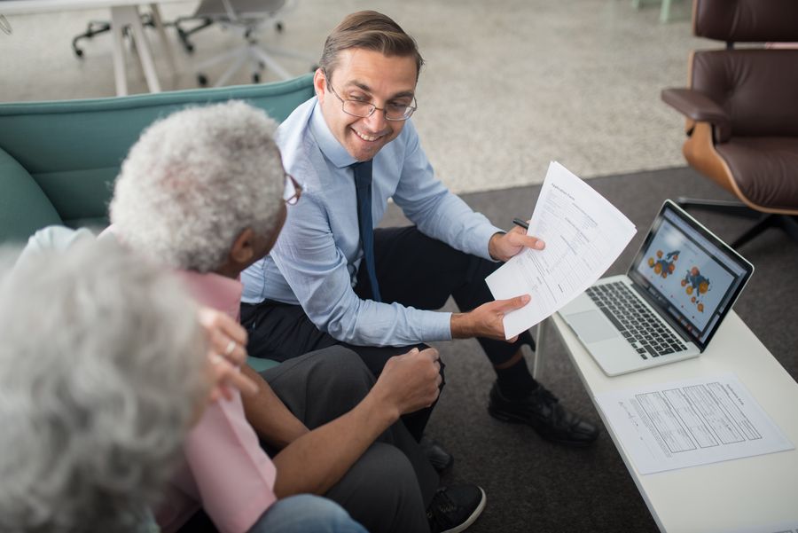 An advisor showing estate documents to a client during an in-office consultation