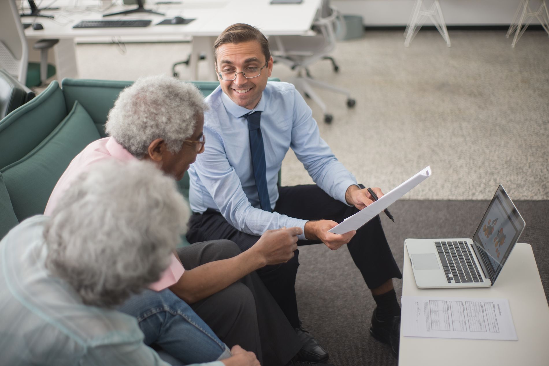 A Summit advisor reviewing a retirement plan with two long-time members