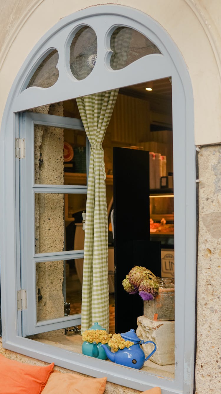 An Open Window With A Clip Curtain