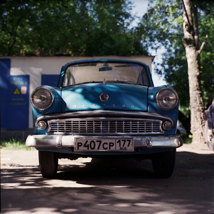 Blue Vintage Car Parked In Shade